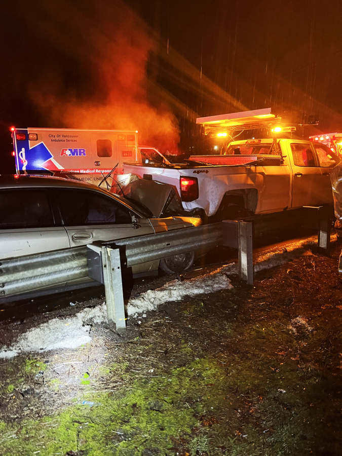 The scene of a Sunday night crash in which a Chevrolet Impala, driven by a suspected drunk driver, rear-ended a Washington State Department of Transportation truck, pushing it into another truck on the shoulder of Interstate 5 near Milepost 8. Seven people were taken to area hospitals for injuries.