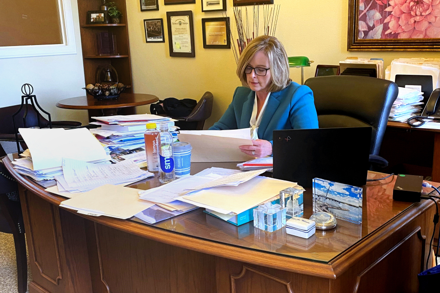 State Sen. Annette Cleveland, D-Vancouver, from the 49th Legislative District, uses the time between committee meetings to talk with constituents, lobbyists and fellow lawmakers in her Olympia office Tuesday.