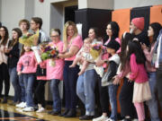 Prior to Washougal’s “Coaches Vs. Cancer” game, the Panthers gave bouquets of flowers and honored three women fighting cancer: Mary Howard, left, Katie Stevens, center, and Melissa Franco, right,  on Thursday, Jan. 25, 2024, at Washougal High School. Stevens, a former Washougal High student and girls basketball player, was diagnosed with breast cancer in 2022. Howard and Franco, both Washougal residents, are cancer survivors.