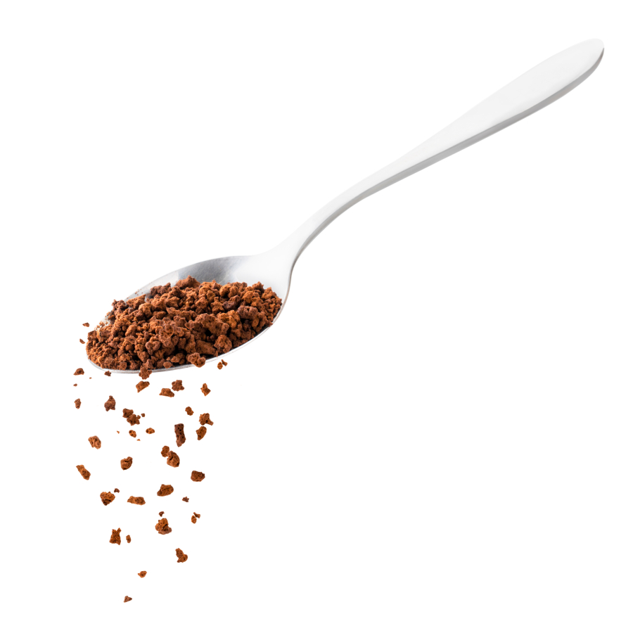 Instant coffee spills from a spoon.