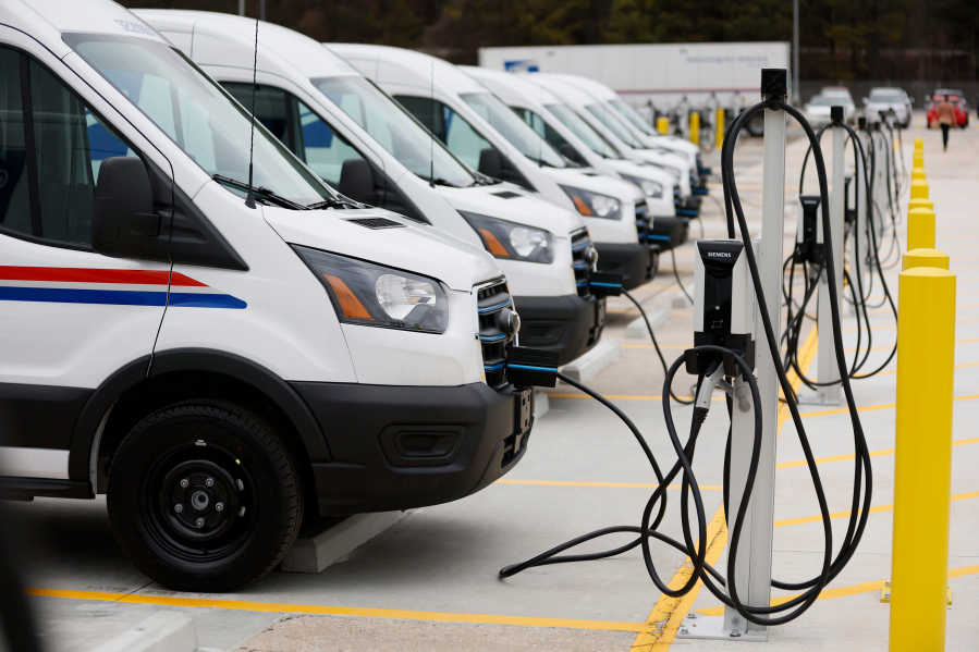 Several United States Postal Service vans are seen charging during the unveiling of the first of tens of thousands of electric vehicles and charging stations deployed nationally to power the country&rsquo;s largest electric delivery fleet on Monday, Jan. 22, 2024.