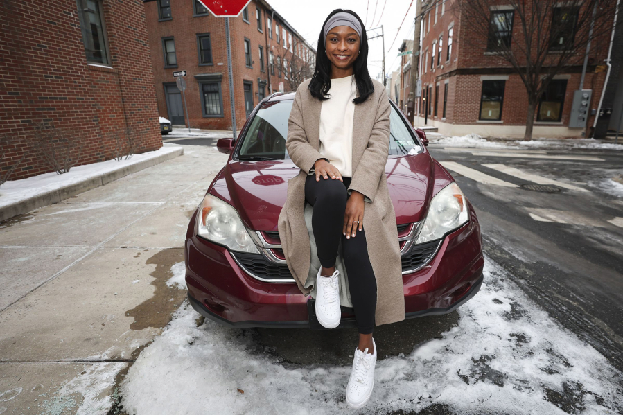 Imani Porter sits on her car in the Northern Liberties section of Philadelphia on Thursday, Jan. 18, 2024. She said a previous insurer wanted to increase her rate 35%, citing inflation.