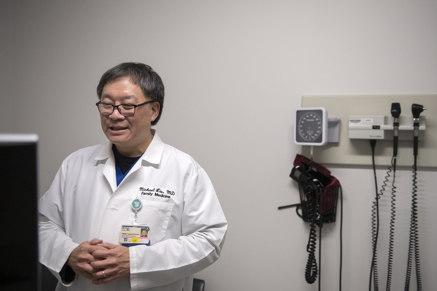 Dr. Michael Liu works behind the scenes at PeaceHealth Family Medicine of Southwest Washington on Jan. 8.