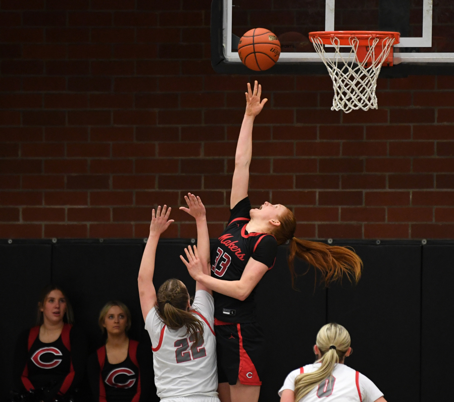 Camas senior Addison Harris (33) shoots a reverse layup while being defending by Union junior Addy Eisfeldt (22) in the 4A Greater St. Helens League game Tuesday. Harris scored 17 points to go with nine rebounds and two blocked shots during the Papermakers&rsquo; 65-43 win at Union High School.