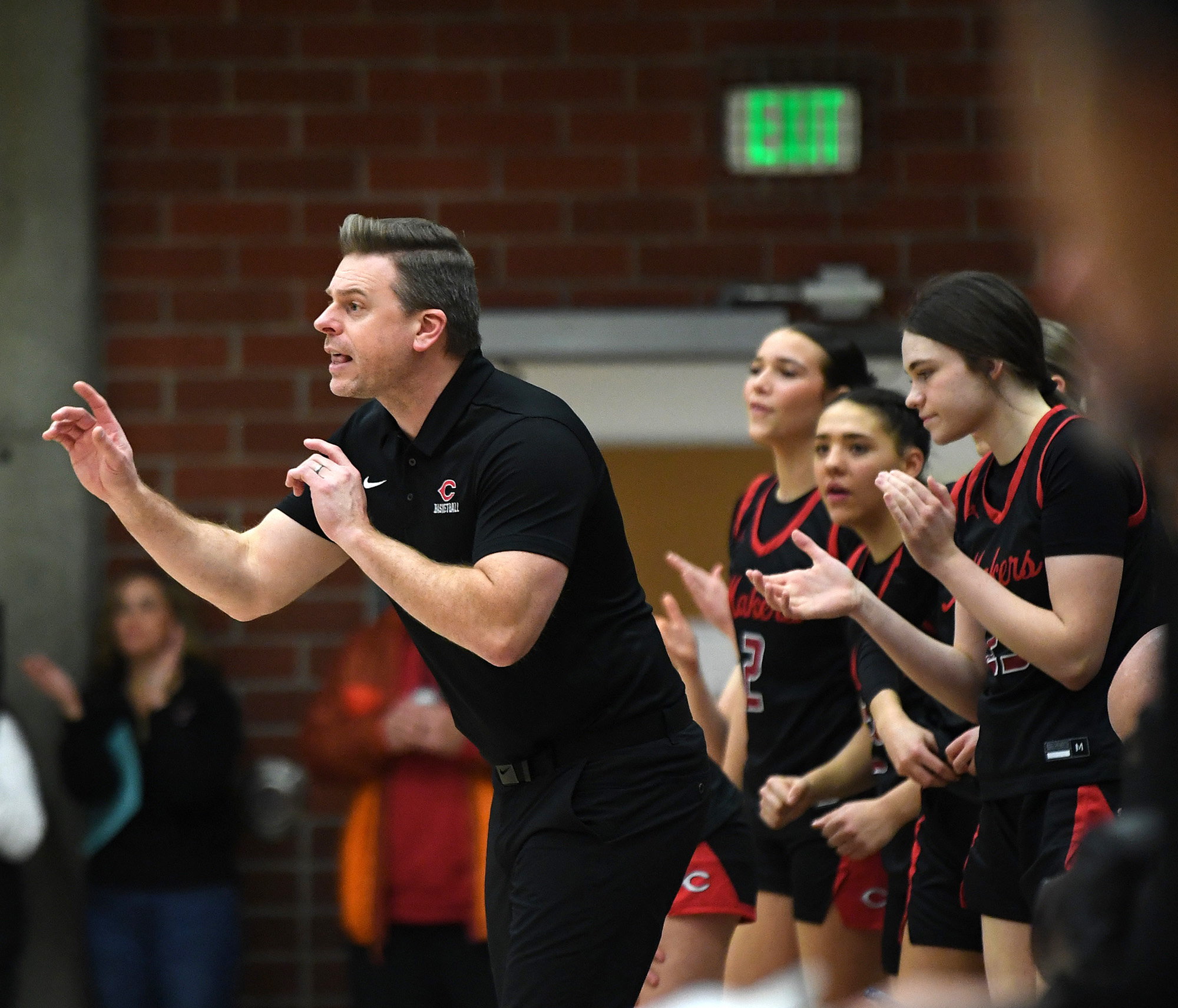 Camas head girls basketball coach Scott Thompson, left, directs the team Tuesday, Jan. 2, 2024, during the Papermakers’ 65-43 win against Union at Union High School.
