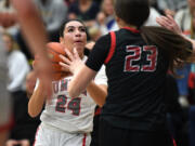 Union senior Ava Smith, left, eyes the basket Tuesday, Jan. 2, 2024, during the Titans’ 65-43 loss to Camas at Union High School.