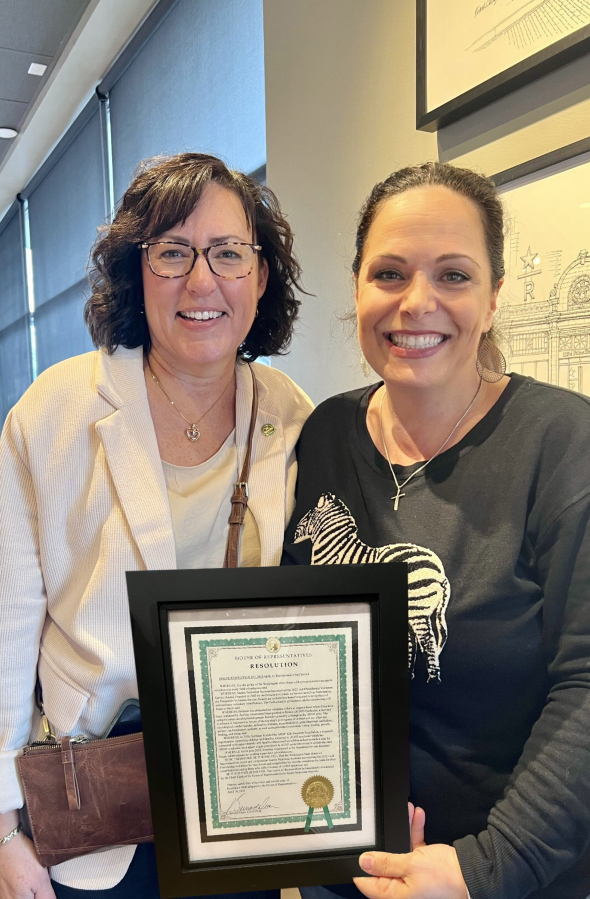 Brush Prairie resident Sandra Sermone, right, and 18th District Rep. Stephanie McClintock, R-Vancouver, with the House resolution presented in her honor.
