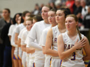 Columbia River junior Marley Myers, right, and the rest of the team stand during the national anthem Friday, Jan. 5, 2024, during the Rapids’ 43-33 win against Ridgefield at Columbia River High School.