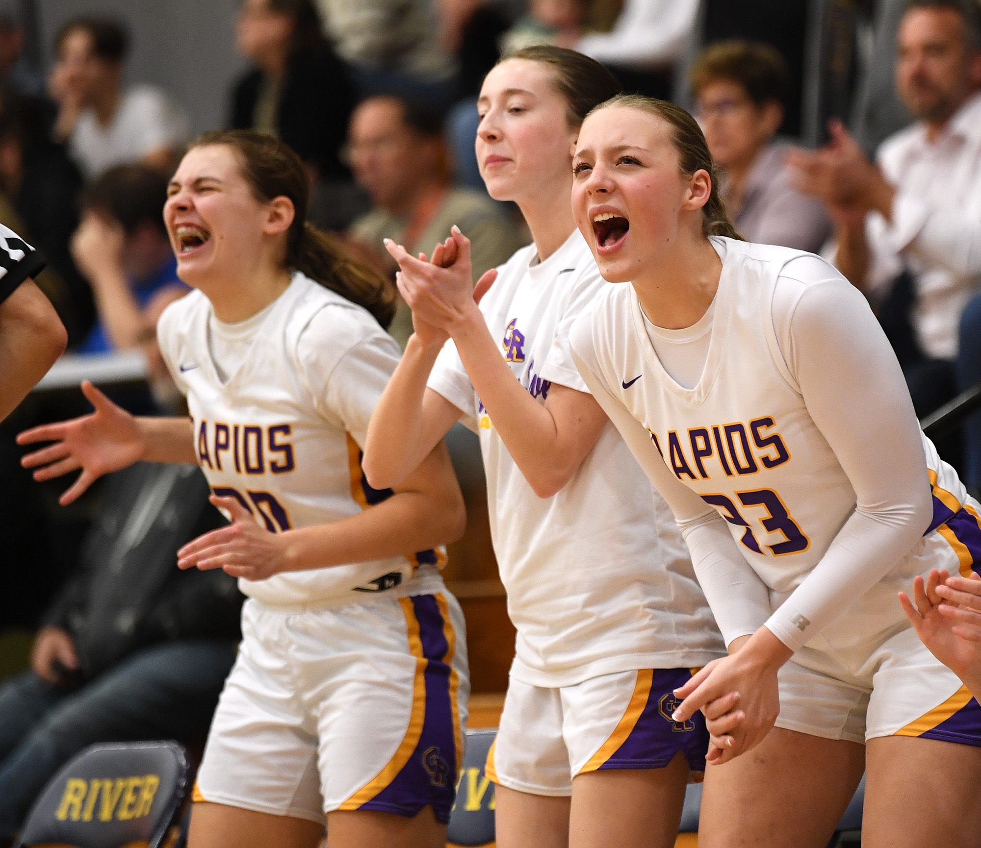 Columbia River junior Kaya Mirtich, right, and Columbia River junior Brooklyn Moore, left, celebrate with the bench after a basket Friday, Jan. 5, 2024, during the Rapids’ 43-33 win against Ridgefield at Columbia River High School.