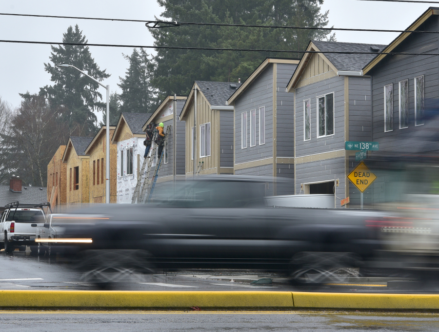 Cars pass in front of a construction site along Northeast 138th Avenue in east Vancouver. The local building industry is working with schools to funnel more young people into skilled trades professions.