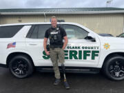 Clark County sheriff&rsquo;s Deputy Drew Kennison poses in front of his new patrol SUV on Friday before returning to his first patrol shift Saturday morning since a snow-heavy tree crushed his previous vehicle. The incident caused Kennison&rsquo;s left leg to be amputated above the knee, but he immediately sought to return to work.