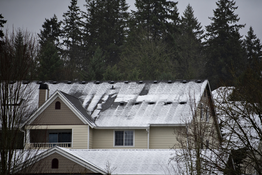 A light blanket of snow is seen on rooftops in Salmon Creek on Wednesday morning, Jan. 10, 2024.