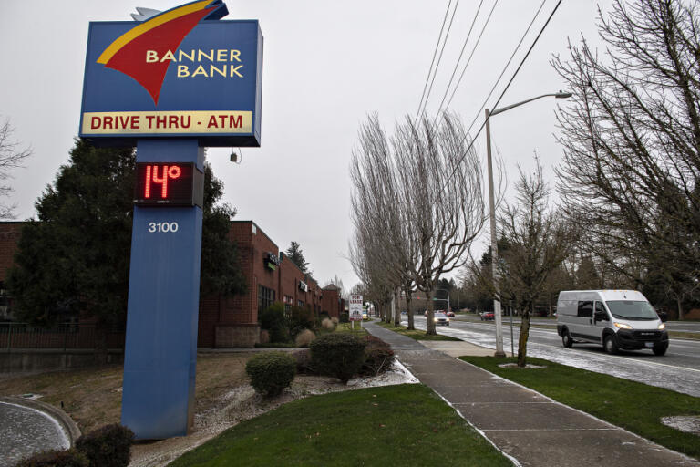 A bank sign in Fisher&rsquo;s Landing reflects frigid temperatures as drivers navigate gusty winds Saturday morning, Jan. 13, 2024.