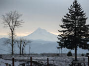 Mount Hood, seen from the Port of Camas-Washougal on Tuesday morning, shows a fresh coat of white after the weekend&rsquo;s winter storm. The Western United States experienced record low snow in early January.
