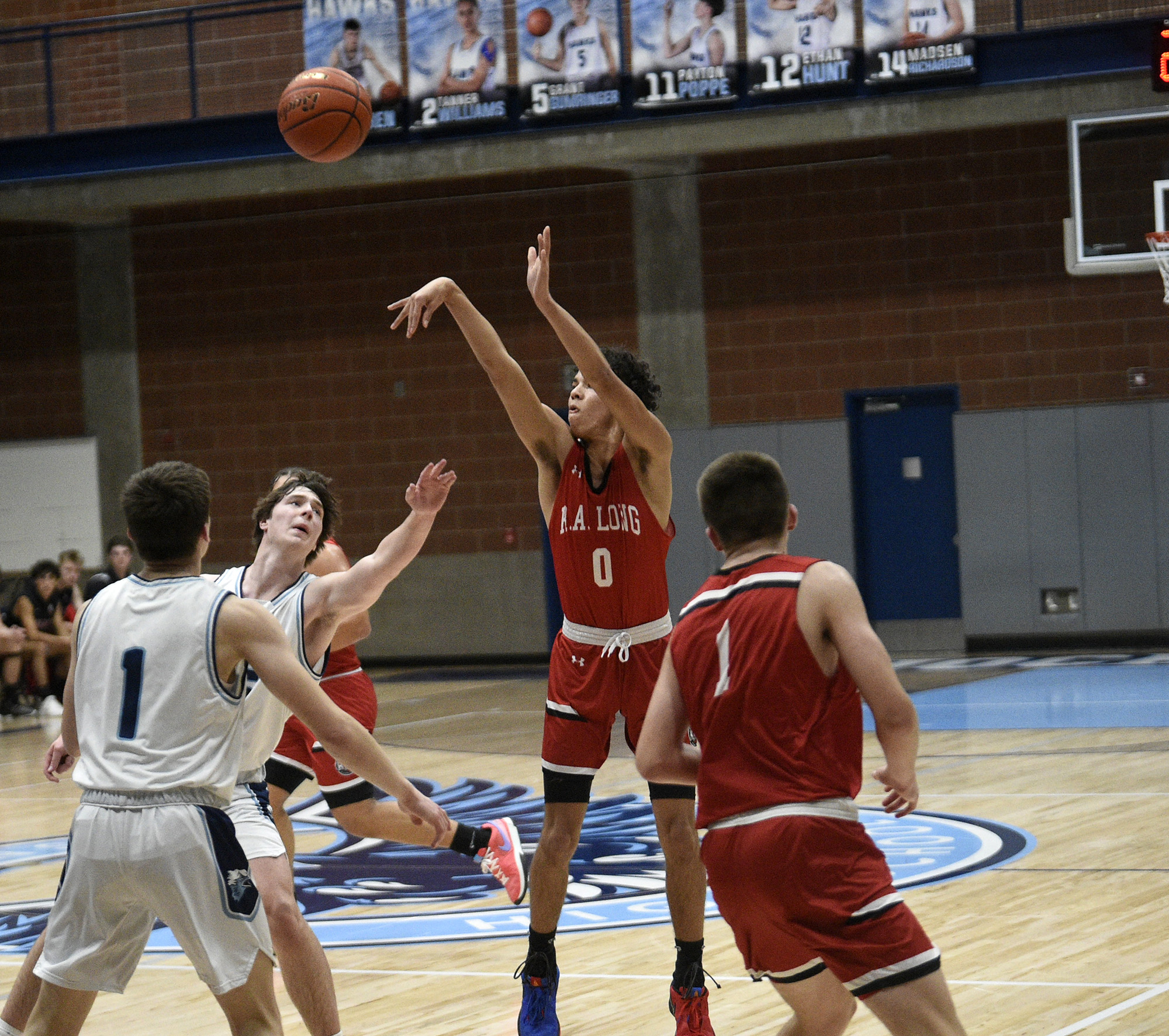 R.A. Long senior Lonnie Brown Jr. (0) takes a 3-point shot during the Lumberjacks’ 67-47 win over Hockinson in a 2A Greater St. Helens League boys basketball game at Hockinson High School on Thursday, Jan. 11, 2024.