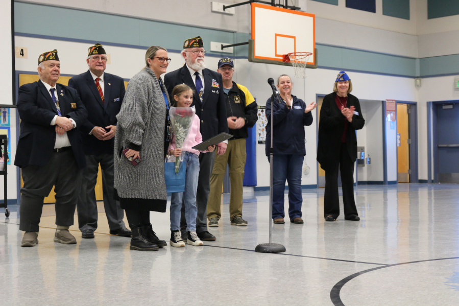 Scout Eldridge, student at Gause Elementary School, is recognized by VFW Post 4278 as a State Junior Essay Contest award winner at a schoolwide assembly.