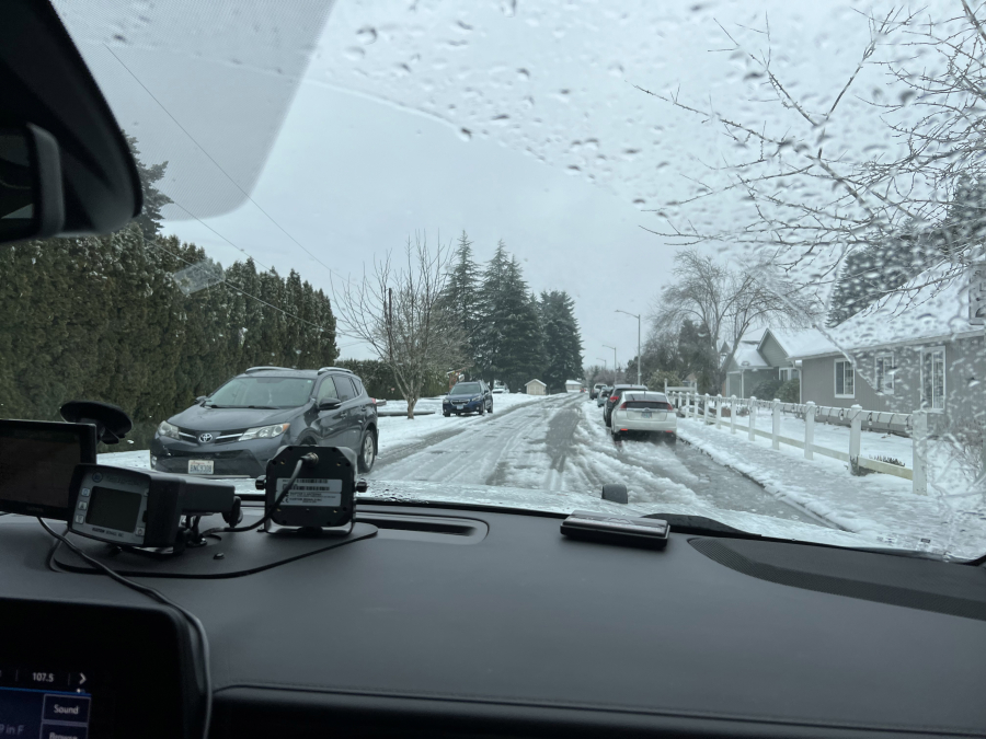 Vehicles drive over icy streets Thursday afternoon in a Salmon Creek neighborhood. Emergency responders navigated icy and slushy roads to respond to calls for help throughout Clark County.