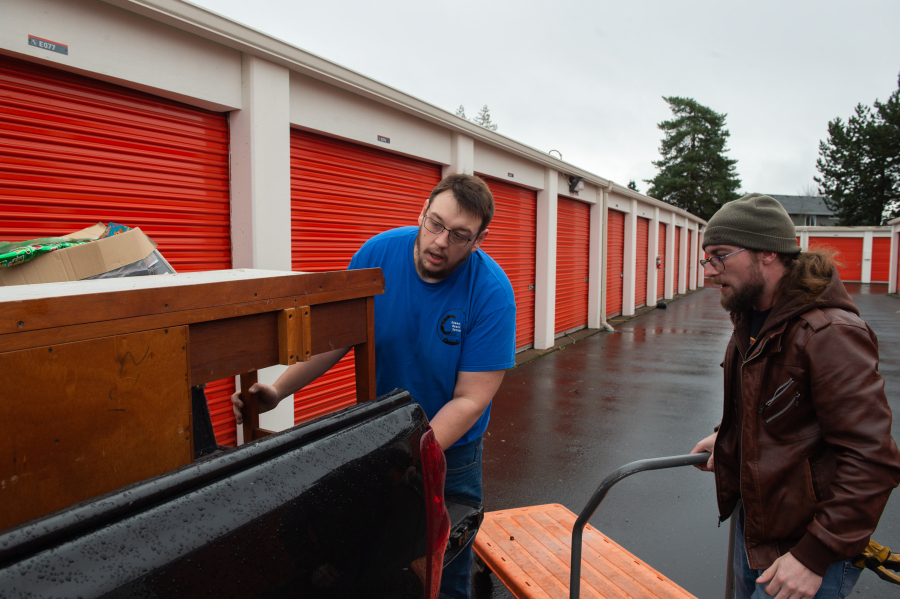James Rexroad/for The Columbian
Connor Murphy of Connor&rsquo;s Hauling Service, left, along with his helper, Ben Reese of Vancouver,  empty a storage unit.
