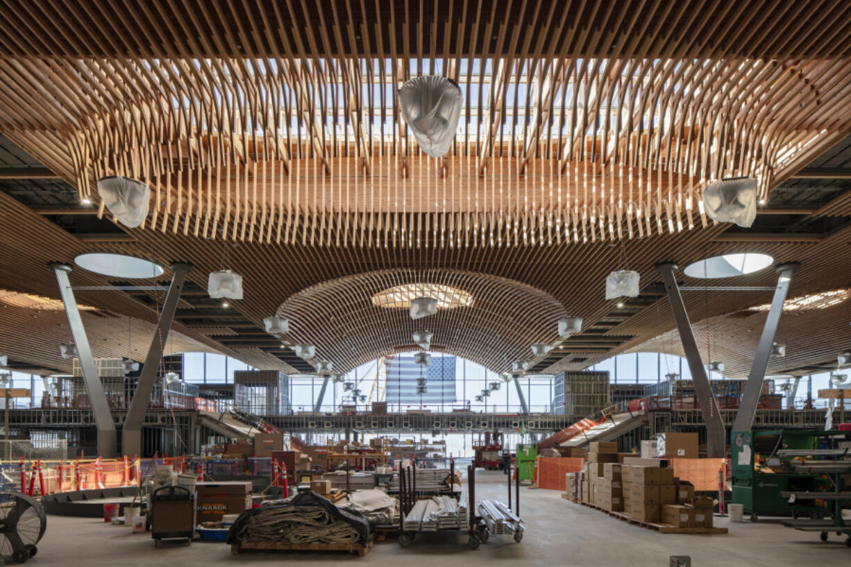 In a sense, the main terminal&rsquo;s new roof is one of the world&rsquo;s largest wooden puzzles. It can be separated into 20 individual pieces which were moved from the fabrication yard, located three-quarters of a mile down the tarmac, to the main terminal. Each piece weighs at least 600,000 pounds and took four nights to be moved into place. (Photos by Stephen A.