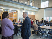 Clark College President Karin Edwards, left, talks with Washington State University Vancouver Chancellor Mel Netzhammer before speaking to the crowd at Clark College on Monday morning.