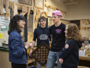 LEADOPTION Rep. Marie Gluesenkamp Perez, from left, pauses to chat with sophomore Brandon Lee, 16, junior Luke Livengood, 17, and senior Kiersten Lees, 17, while visiting their woodshop class at Washougal High School on Wednesday morning. Perez was on campus to speak with students and instructors supporting and expanding pathways for trades careers.