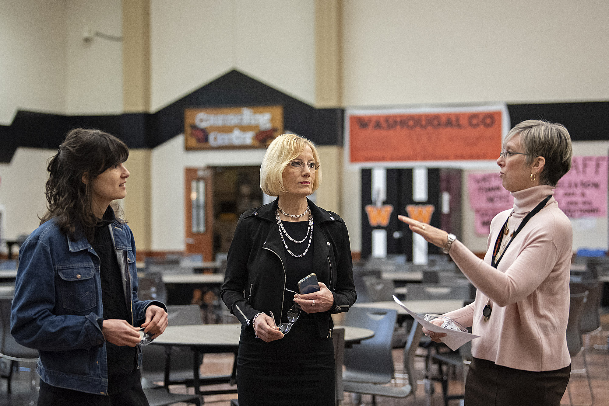 Rep. Marie Gluesenkamp Perez, from left, pauses to chat with Washougal School District Superintendent Mary Templeton and Margaret Rice, career and technical education director, at Washougal High School on Jan. 24.