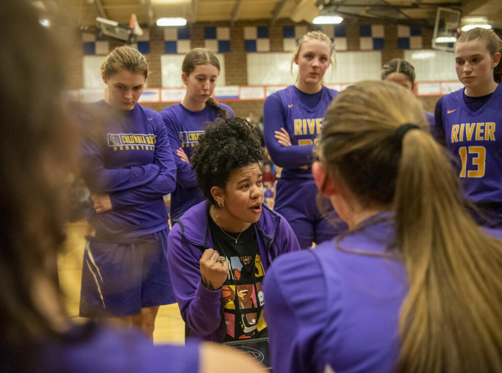 Columbia River head girls basketball coach Tuileisu Anderson, center, talks to the team Wednesday, Jan. 31, 2024, during the Rapids’ 54-47 win against Ridgefield at Ridgefield High School.