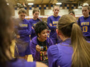 Columbia River head girls basketball coach Tuileisu Anderson, center, talks to the team Wednesday, Jan. 31, 2024, during the Rapids’ 54-47 win against Ridgefield at Ridgefield High School.