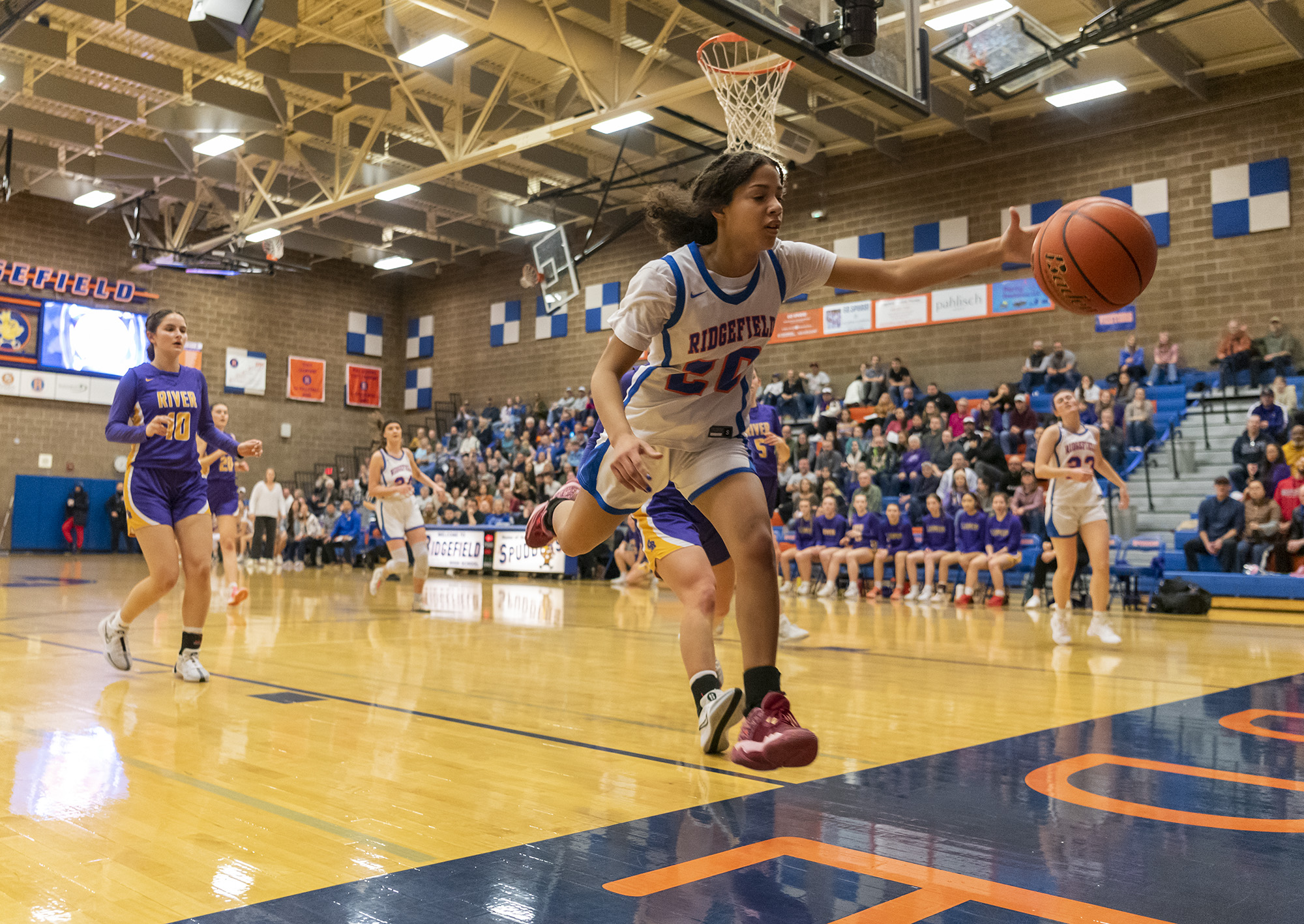 Ridgefield freshman Jalise Chatman leaps for a loose ball Wednesday, Jan. 31, 2024, during the Spudders’ 54-47 loss to Columbia River at Ridgefield High School.