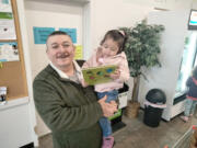 Carly Martinez-Torres and her dad, Salvador, were glad to receive a free book at FISH of Vancouver on a recent morning.