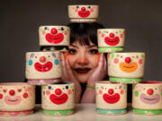 Soraya Yousefi poses with her bowls and cups. &ldquo;I&rsquo;m such a maximalist,&rdquo; she said. &ldquo;I hate empty space, including on my own face, so I&rsquo;ve always had doodles around my face and little dots.