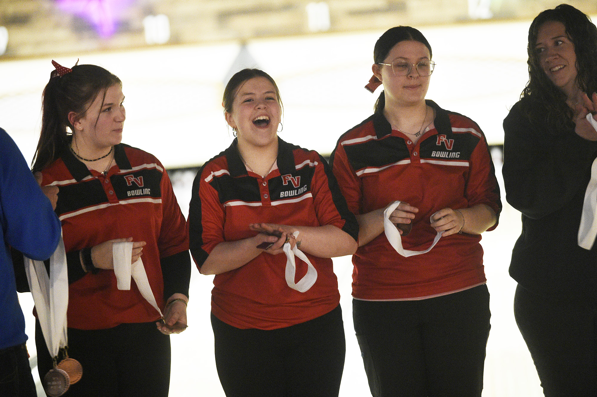 Fort Vancouver bowlers, from left, Annabelle Wiley, Lacey McHan and Lilly Peschka celebrate along with coach Lauryn Heying (far right) after placing third at the 2A girls bowling district tournament at Triangle Bowl in Longview on Friday, Jan. 26, 2024.