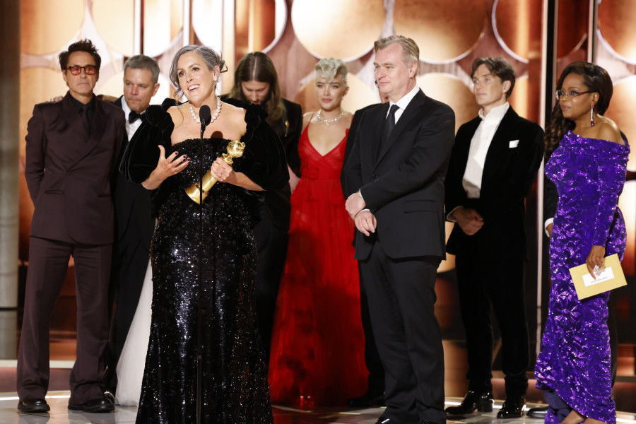 This image released by CBS shows producer Emma Thomas, foreground left, accepting the award for best motion picture drama for &ldquo;Oppenheimer&rdquo; as cast and crew members, background from left, Robert Downey Jr., Matt Damon, composer Ludwig G&ouml;ransson, Florence Pugh, director Christopher Nolan, actor Cillian Murphy and presenter Oprah Winfrey look on during the 81st Annual Golden Globe Awards in Beverly Hills, Calif., on Sunday, Jan. 7, 2024.