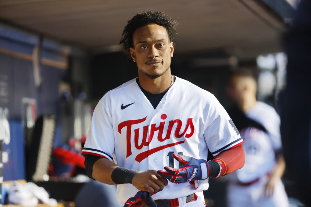 Minnesota Twins' Jorge Polanco walks in the dugout after striking out in the third inning of Game 3 of an American League Division Series baseball game against the Houston Astros, Tuesday, Oct. 10, 2023, in Minneapolis.