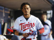 Minnesota Twins' Jorge Polanco walks in the dugout after striking out in the third inning of Game 3 of an American League Division Series baseball game against the Houston Astros, Tuesday, Oct. 10, 2023, in Minneapolis.