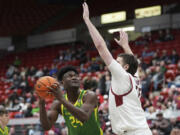 Oregon center Mahamadou Diawara (24) looks to shoot past Washington State forward Oscar Cluff during the first half of an NCAA college basketball game Saturday, Jan. 6, 2024, in Pullman, Wash. (AP Photo/Ted S.