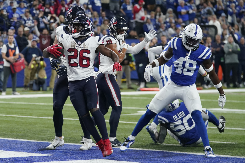 Houston Texans running back Devin Singletary (26) scores a rushing touchdown during the second half of an NFL football game against the Indianapolis Colts, Saturday, Jan. 6, 2024, in Indianapolis.