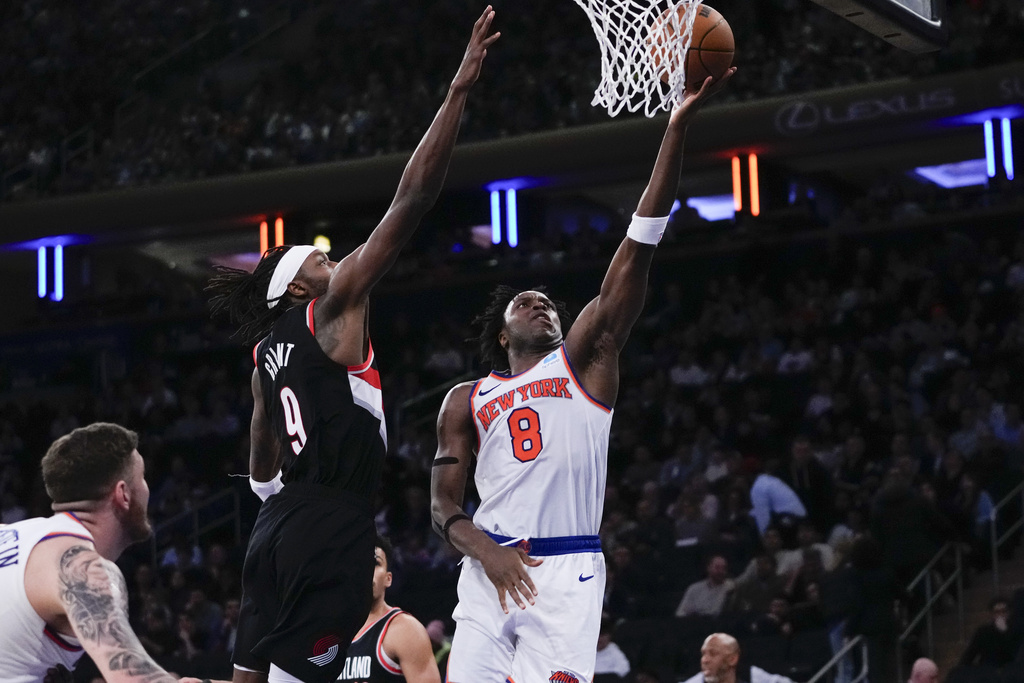 New York Knicks' OG Anunoby (8) drives past Portland Trail Blazers' Jerami Grant (9) during the second half of an NBA basketball game Tuesday, Jan. 9, 2024, in New York. The Knicks won 112-84.