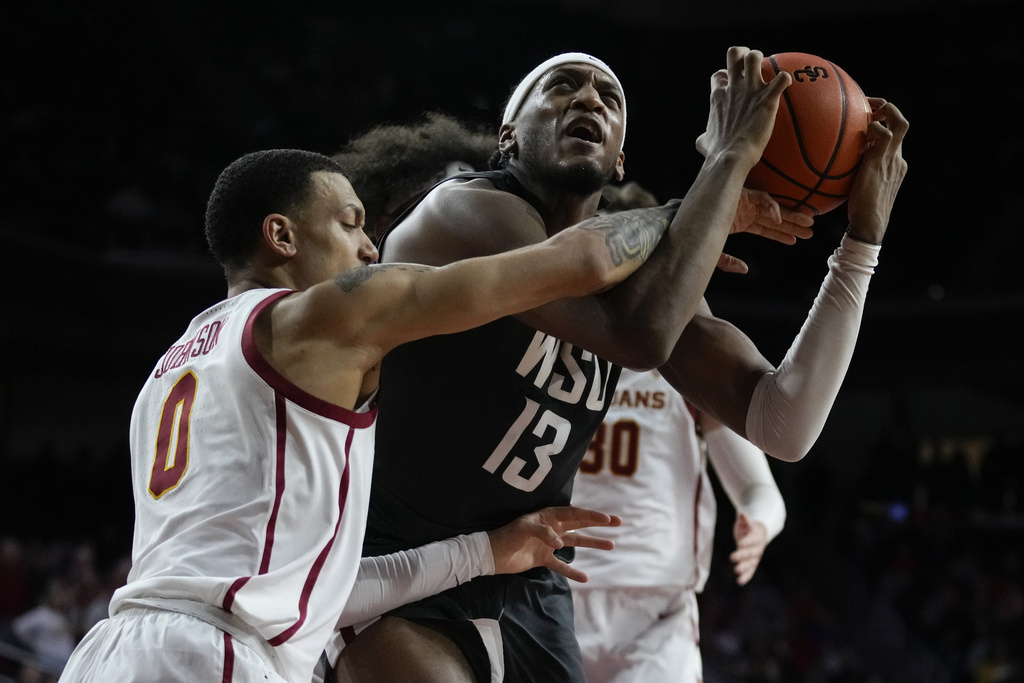 Southern California guard Kobe Johnson (0) fouls Washington State forward Isaac Jones (13) during the second half of an NCAA college basketball game in Los Angeles, Wednesday, Jan. 10, 2024.