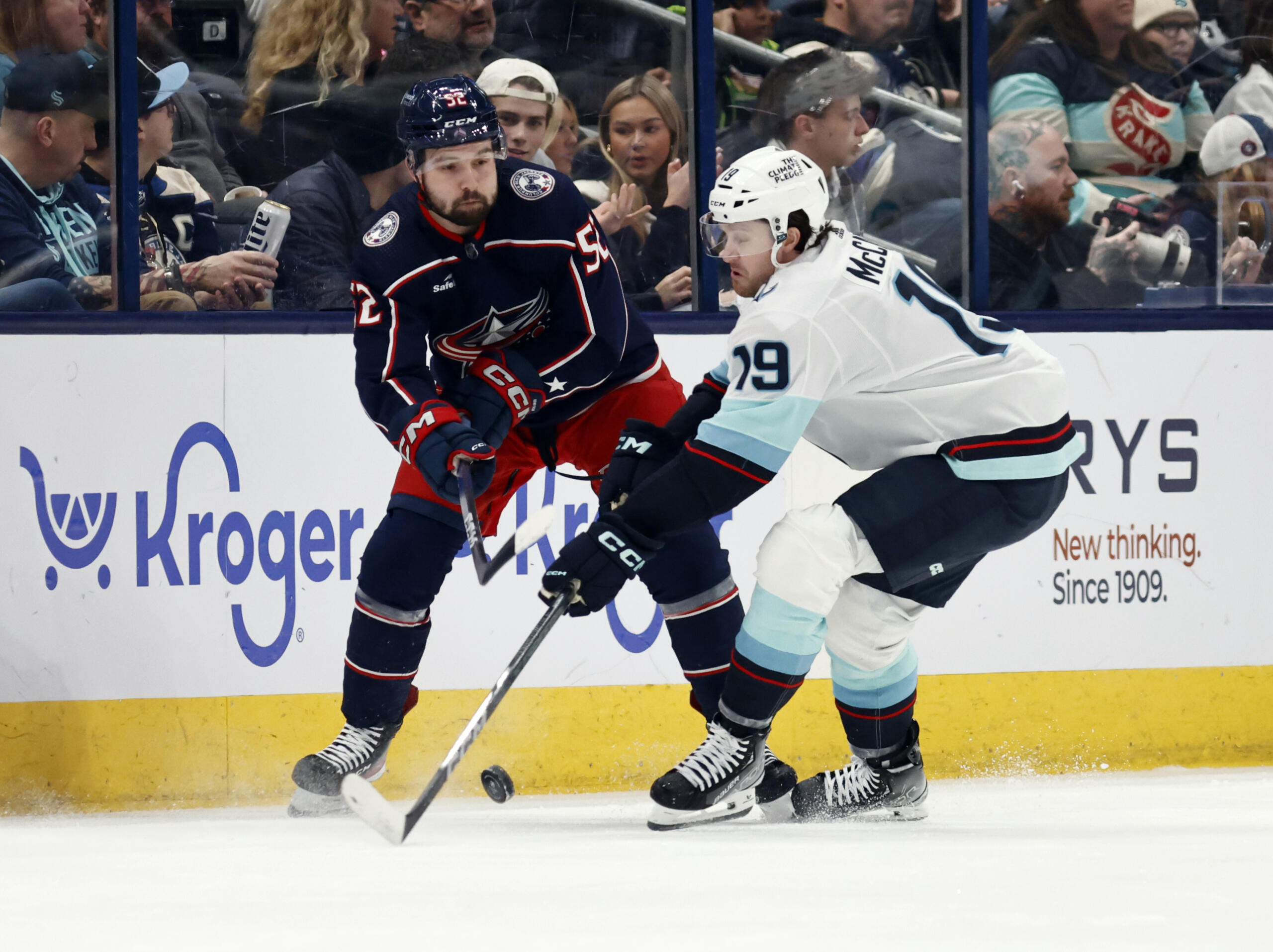 Columbus Blue Jackets forward Emil Bemstrom, left, passes the puck in front of Seattle Kraken forward Jared McCann during the first period NHL hockey game in Columbus, Ohio, Saturday, Jan. 13, 2024.