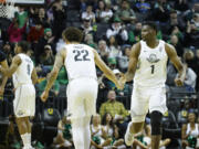 Oregon center N'Faly Dante (1) celebrates with Oregon guard Jadrian Tracey (22) against California during the second half of an NCAA college basketball game in Eugene, Ore., Saturday, Jan. 13, 2024.