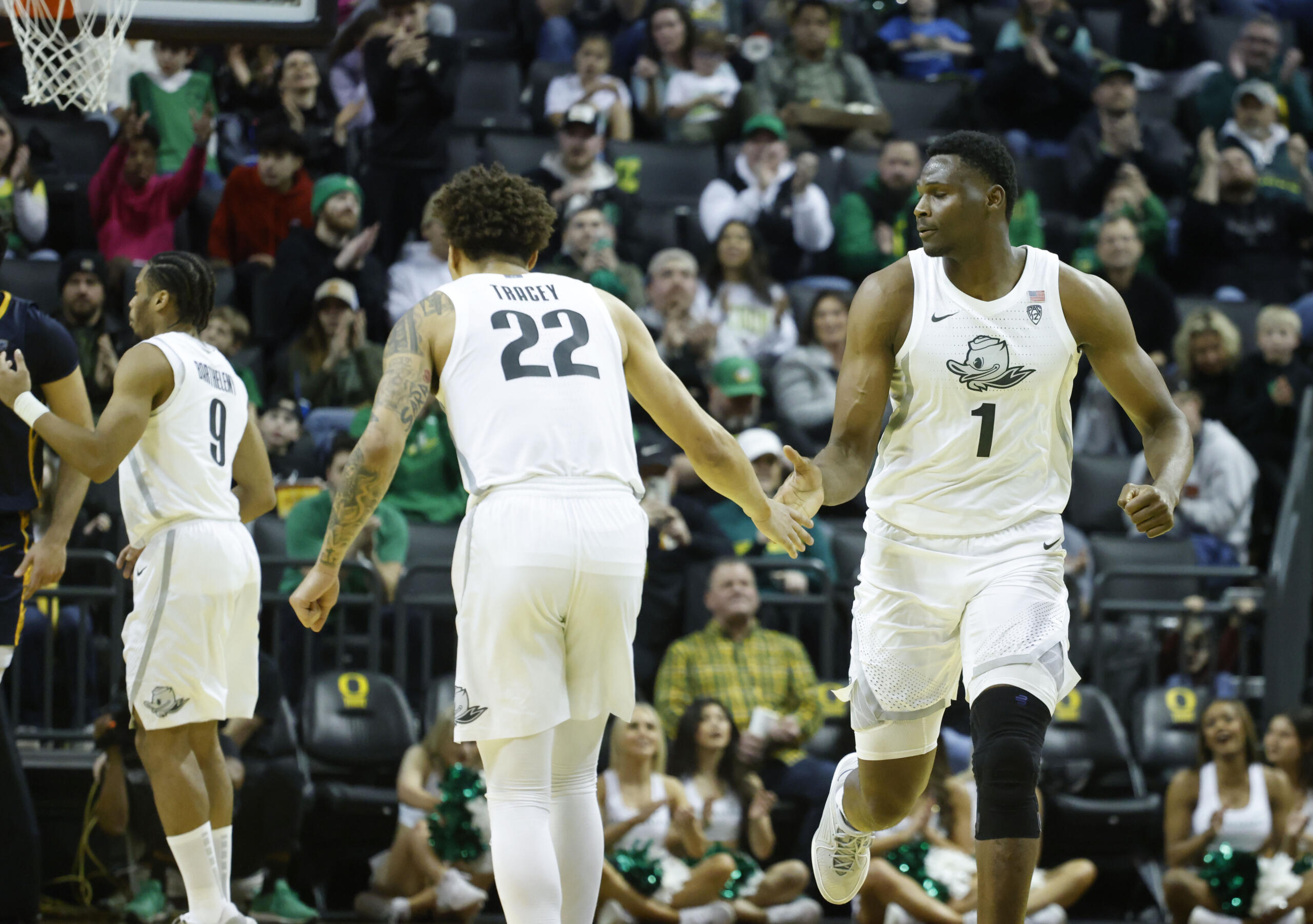 Oregon center N'Faly Dante (1) celebrates with Oregon guard Jadrian Tracey (22) against California during the second half of an NCAA college basketball game in Eugene, Ore., Saturday, Jan. 13, 2024.
