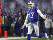Buffalo Bills quarterback Josh Allen (17) reacts after throwing a touchdown pass to tight end Dalton Kincaid (86) during the first quarter of an NFL wild-card playoff football game, Monday, Jan. 15, 2024, in Buffalo, N.Y. (AP Photo/Jeffrey T.