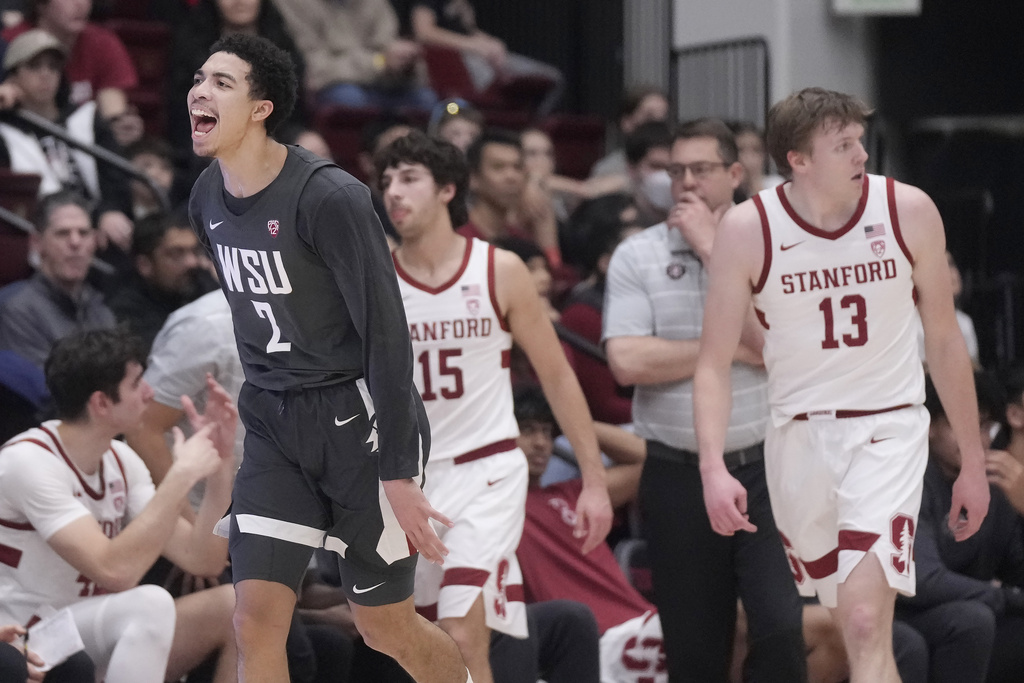 Washington State guard Myles Rice (2) reacts after making a 3-point basket, next to Stanford guard Benny Gealer (15), coach Jerod Haase, second from right, and guard Michael Jones (13) during the first half of an NCAA college basketball game in Stanford, Calif., Thursday, Jan. 18, 2024.