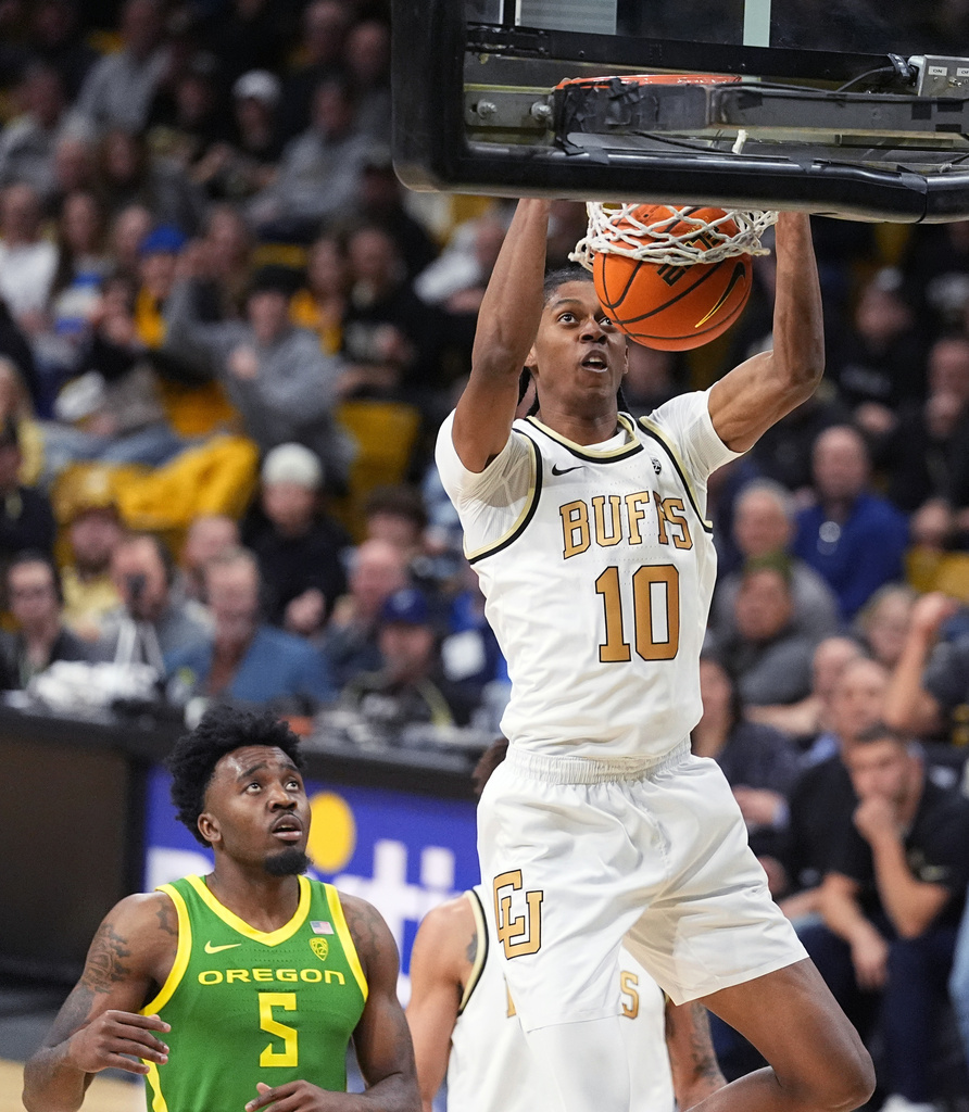 Colorado forward Cody Williams dunks as Oregon guard Jermaine Couisnard watches during the second half of an NCAA college basketball game Thursday, Jan. 18, 2024, in Boulder, Colo.