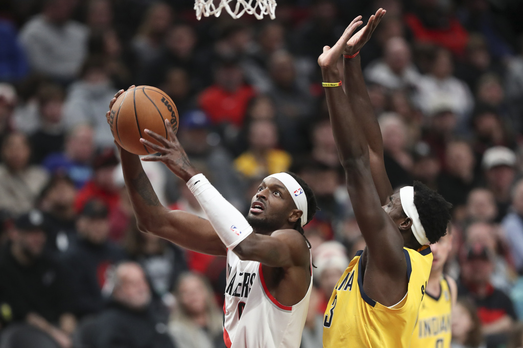 Portland Trail Blazers forward Jerami Grant, left, drives to the basket as Indiana Pacers forward Pascal Siakam defends during the first half of an NBA basketball game Friday, Jan. 19, 2024, in Portland, Ore.