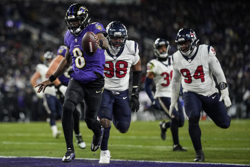 Baltimore Ravens quarterback Lamar Jackson (8) runs into the end zone for a touchdown against the Houston Texans during the second half of an NFL football AFC divisional playoff game, Saturday, Jan. 20, 2024, in Baltimore.