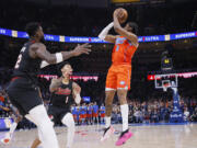 Oklahoma City Thunder forward Jalen Williams (8) prepares to take the game-winning shot as Portland Trail Blazers guard Anfernee Simons (1) and center Deandre Ayton, left, defend during the second half of an NBA basketball game Tuesday, Jan. 23, 2024, in Oklahoma City.