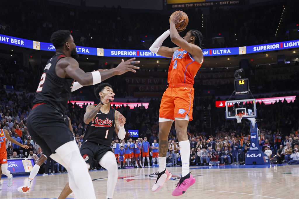 Oklahoma City Thunder forward Jalen Williams (8) prepares to take the game-winning shot as Portland Trail Blazers guard Anfernee Simons (1) and center Deandre Ayton, left, defend during the second half of an NBA basketball game Tuesday, Jan. 23, 2024, in Oklahoma City.