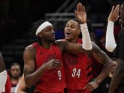 Portland Trail Blazers forward Jerami Grant is congratulated by Jabari Walker after hitting a 3-pointer at the buzzer to send the game against the Houston Rockets to overtime, Wednesday, Jan. 24, 2024, in Houston. (AP Photo/Kevin M.